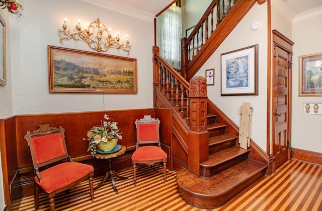 stairway featuring crown molding and carpet floors