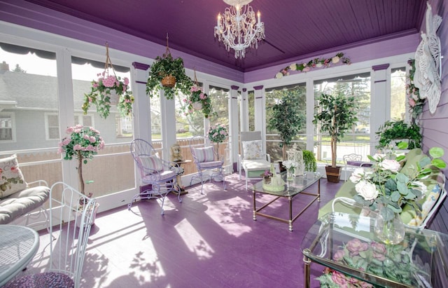 sunroom / solarium featuring plenty of natural light and a chandelier