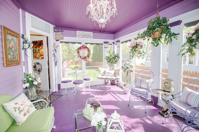 sunroom with wooden ceiling, a wealth of natural light, and a notable chandelier