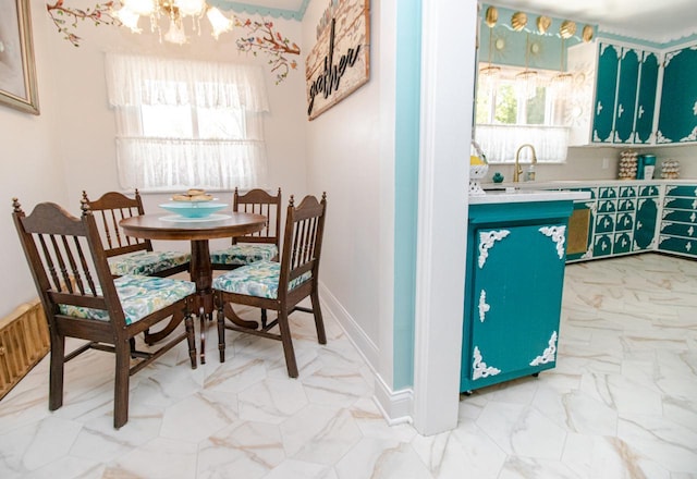 dining area with sink and a chandelier