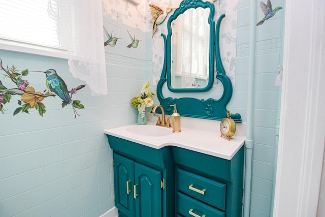 bathroom with vanity and tile walls