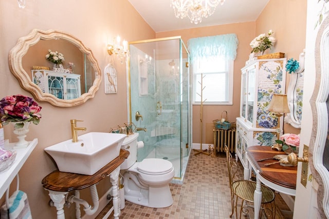 bathroom with a shower with door, radiator, a chandelier, and toilet