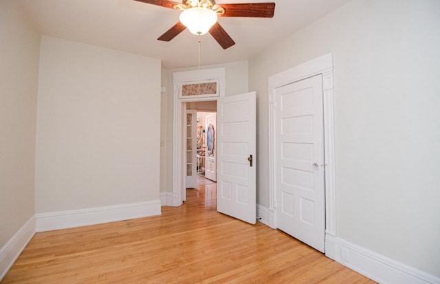 unfurnished bedroom with ceiling fan and light wood-type flooring