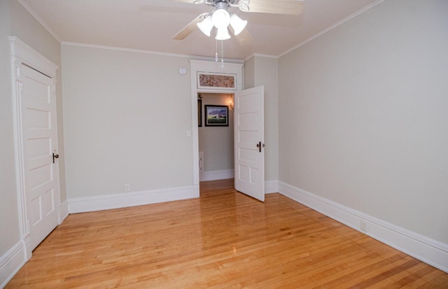 spare room featuring light hardwood / wood-style flooring, ornamental molding, and ceiling fan