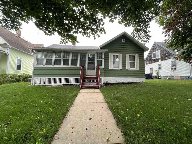 bungalow-style house with a front lawn