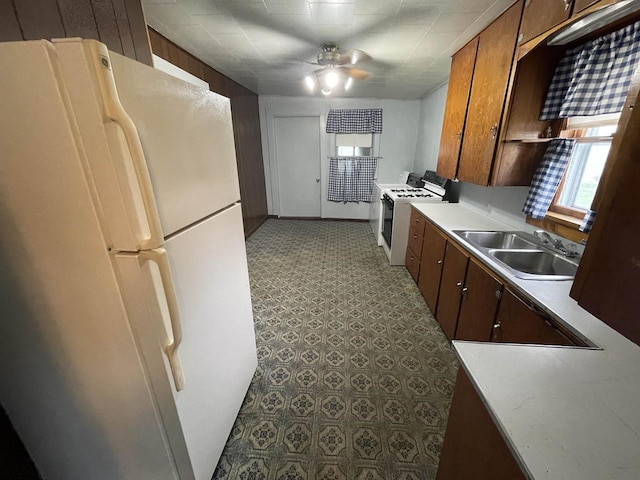 kitchen with ceiling fan, sink, and white appliances