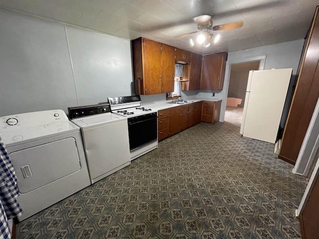 kitchen with sink, white fridge, ceiling fan, gas stove, and washing machine and dryer