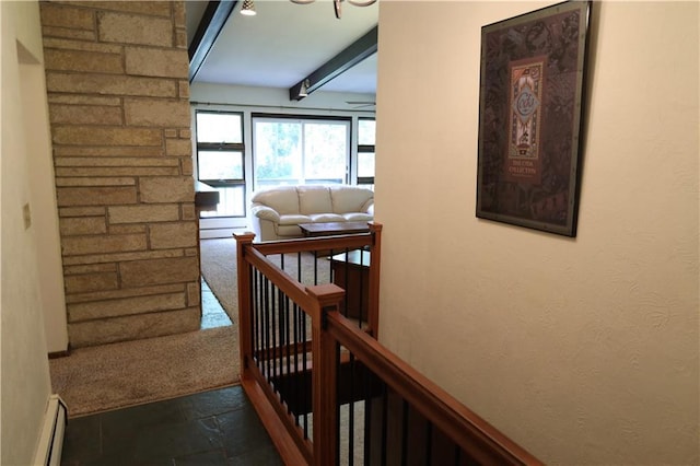 corridor featuring beam ceiling, a baseboard heating unit, and tile patterned floors