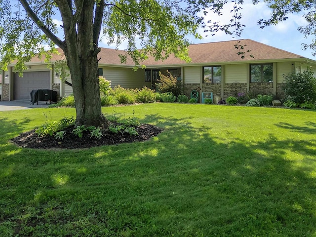 single story home featuring a garage and a front yard