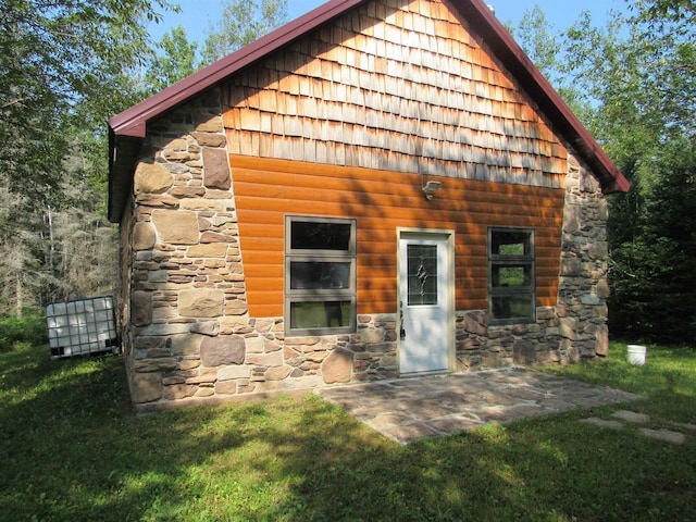 rear view of house with a yard and a patio