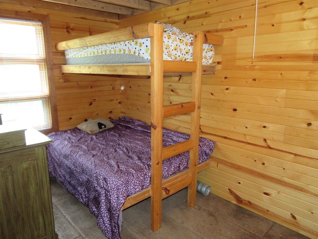 bedroom featuring wooden walls