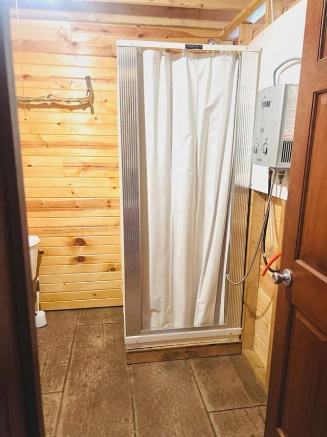 bathroom featuring wood walls and a shower with shower curtain