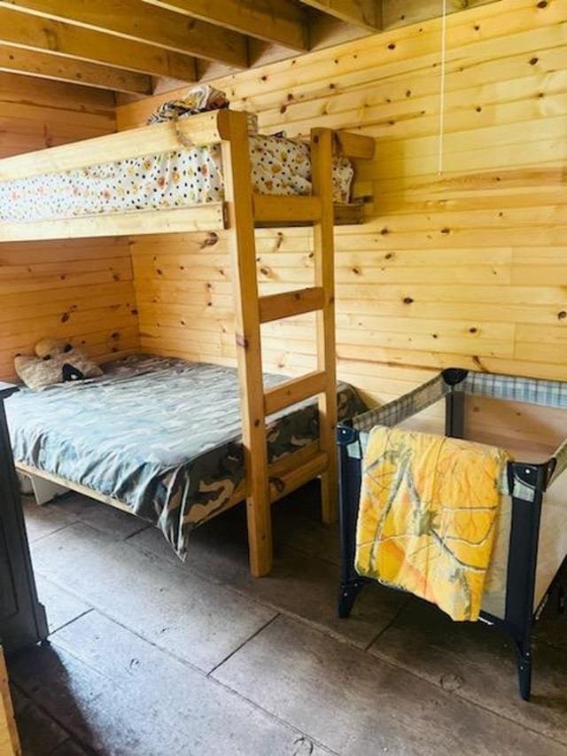 unfurnished bedroom featuring wood walls