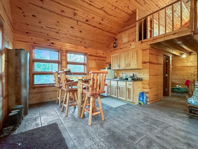 dining room with high vaulted ceiling, wood ceiling, and wood walls