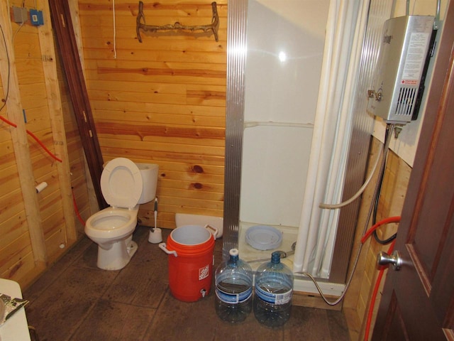 bathroom featuring wood walls, toilet, and tile patterned floors