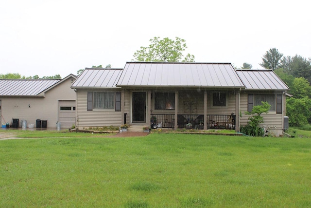 ranch-style home with a garage, covered porch, and a front lawn