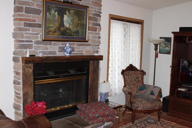 interior space featuring hardwood / wood-style flooring, brick wall, and a wealth of natural light