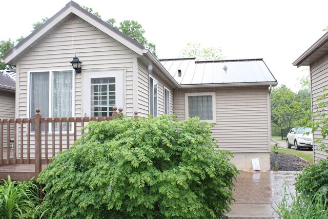 bungalow-style house featuring a wooden deck