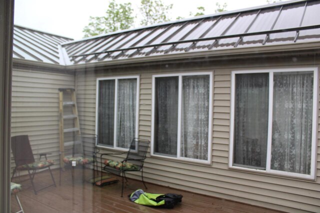 view of side of property featuring a wooden deck