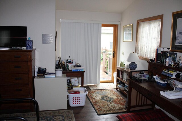 office area with hardwood / wood-style flooring, vaulted ceiling, and a wealth of natural light