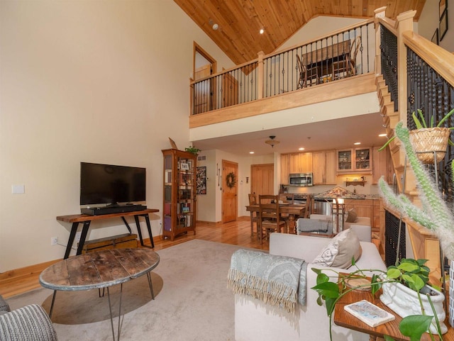 living room featuring high vaulted ceiling, wood ceiling, and light hardwood / wood-style floors