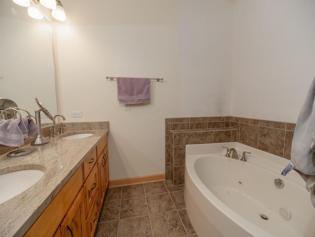 bathroom with tile patterned floors, vanity, and a bath