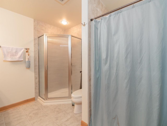 bathroom with toilet, curtained shower, and tile patterned flooring