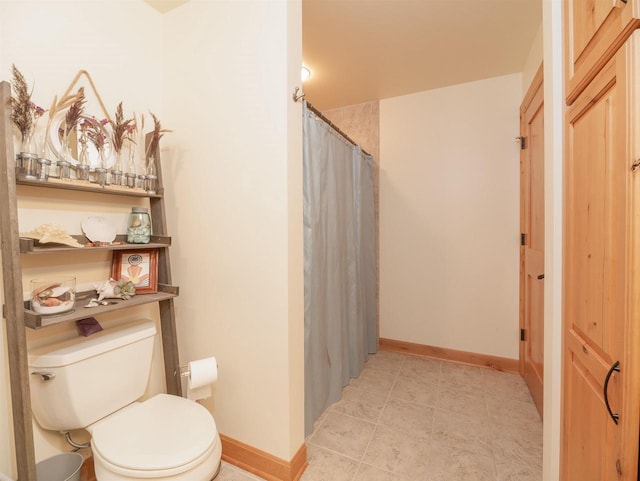 bathroom with a shower with curtain and toilet