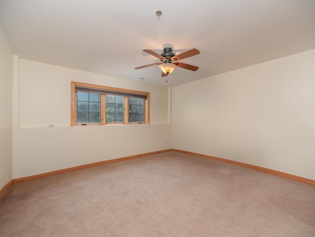 unfurnished room featuring ceiling fan and carpet