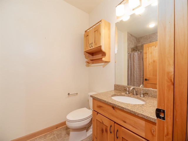 bathroom featuring vanity, tile patterned flooring, toilet, and walk in shower