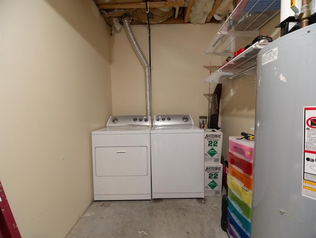 washroom featuring water heater and washer and dryer