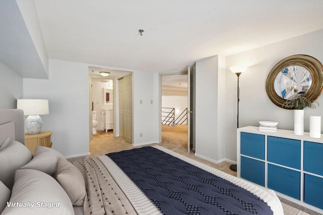 bedroom featuring light carpet and ensuite bathroom