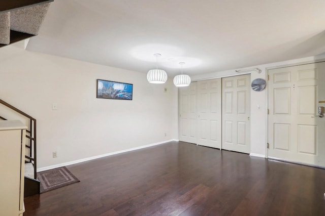 unfurnished living room with dark hardwood / wood-style flooring