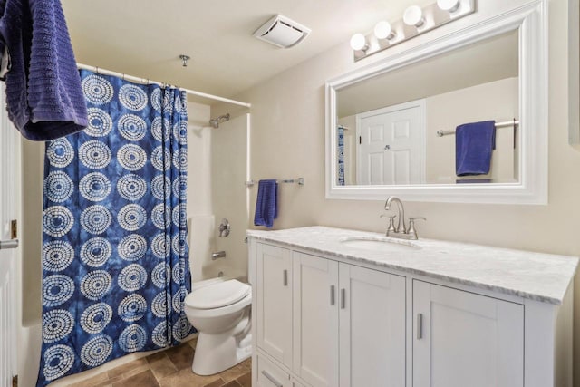 full bathroom featuring shower / tub combo with curtain, tile patterned floors, vanity, and toilet