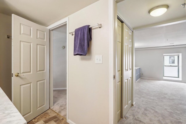 corridor with light colored carpet