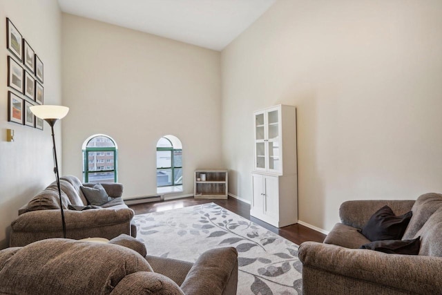 living room with high vaulted ceiling, dark wood-type flooring, and baseboard heating