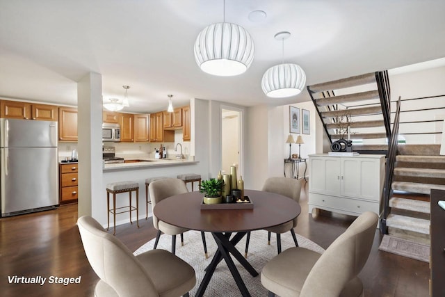 dining area featuring sink and dark hardwood / wood-style flooring