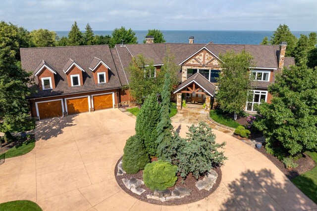 view of front of house featuring a garage and a water view