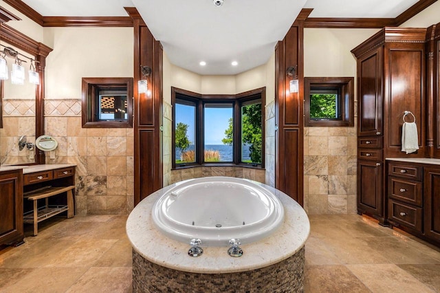 bathroom with vanity, tile walls, crown molding, and a relaxing tiled tub