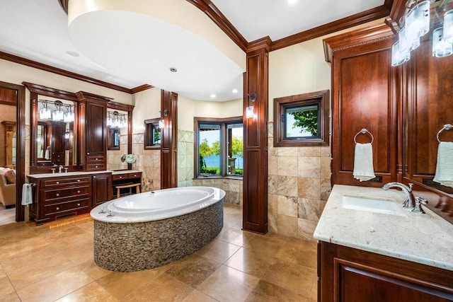 bathroom featuring tile walls, vanity, crown molding, and tiled bath