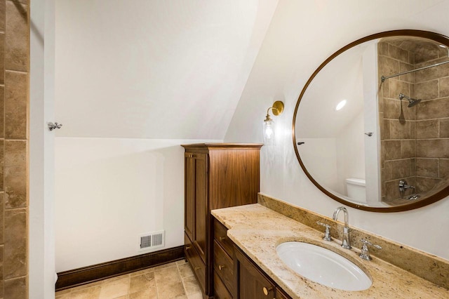 bathroom with shower / bathtub combination, vanity, and vaulted ceiling