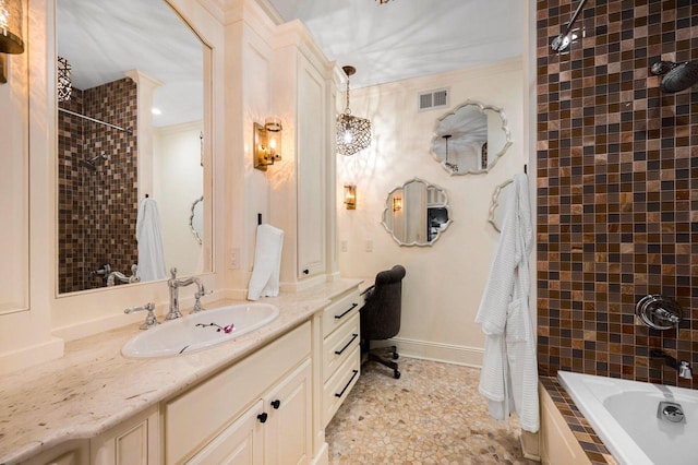 bathroom with vanity, tiled shower / bath combo, and ornamental molding