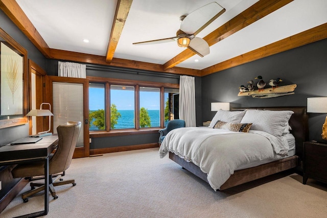 carpeted bedroom with ceiling fan, a water view, and beam ceiling