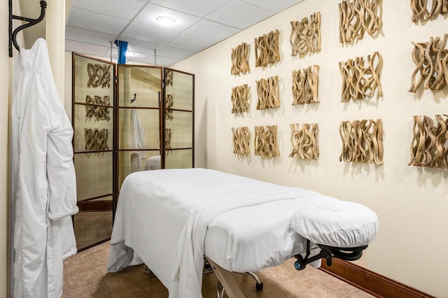 tiled bedroom with a drop ceiling