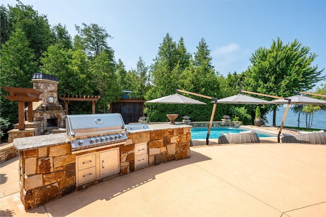 view of patio featuring an outdoor stone fireplace, a water view, area for grilling, and grilling area