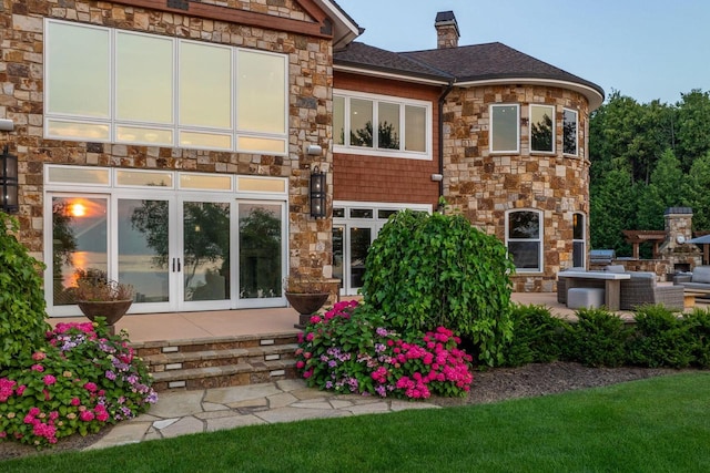 rear view of house featuring a patio and french doors