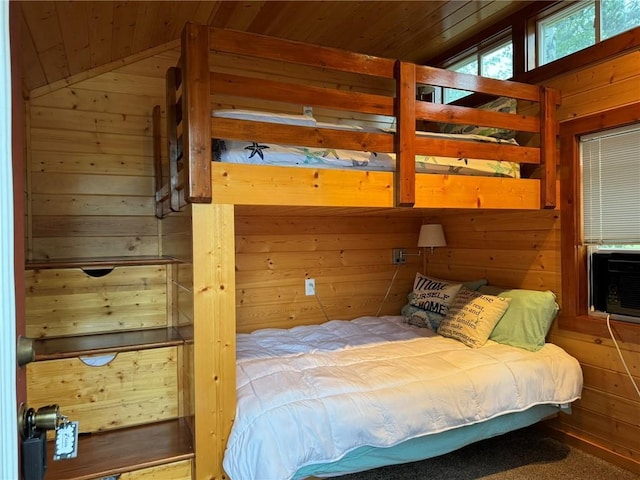 bedroom with lofted ceiling, wooden ceiling, and wood walls