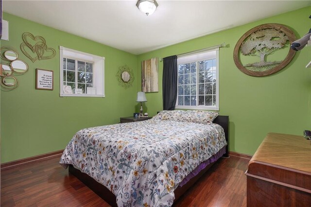 bedroom with dark wood-type flooring