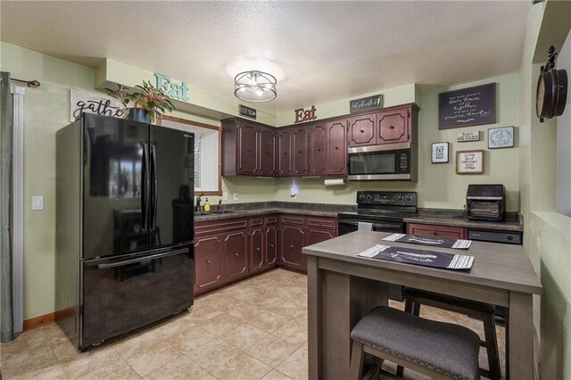 kitchen featuring sink, black appliances, a textured ceiling, and light tile patterned floors