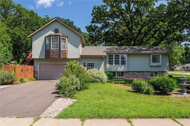 view of front of house featuring a garage and a front lawn